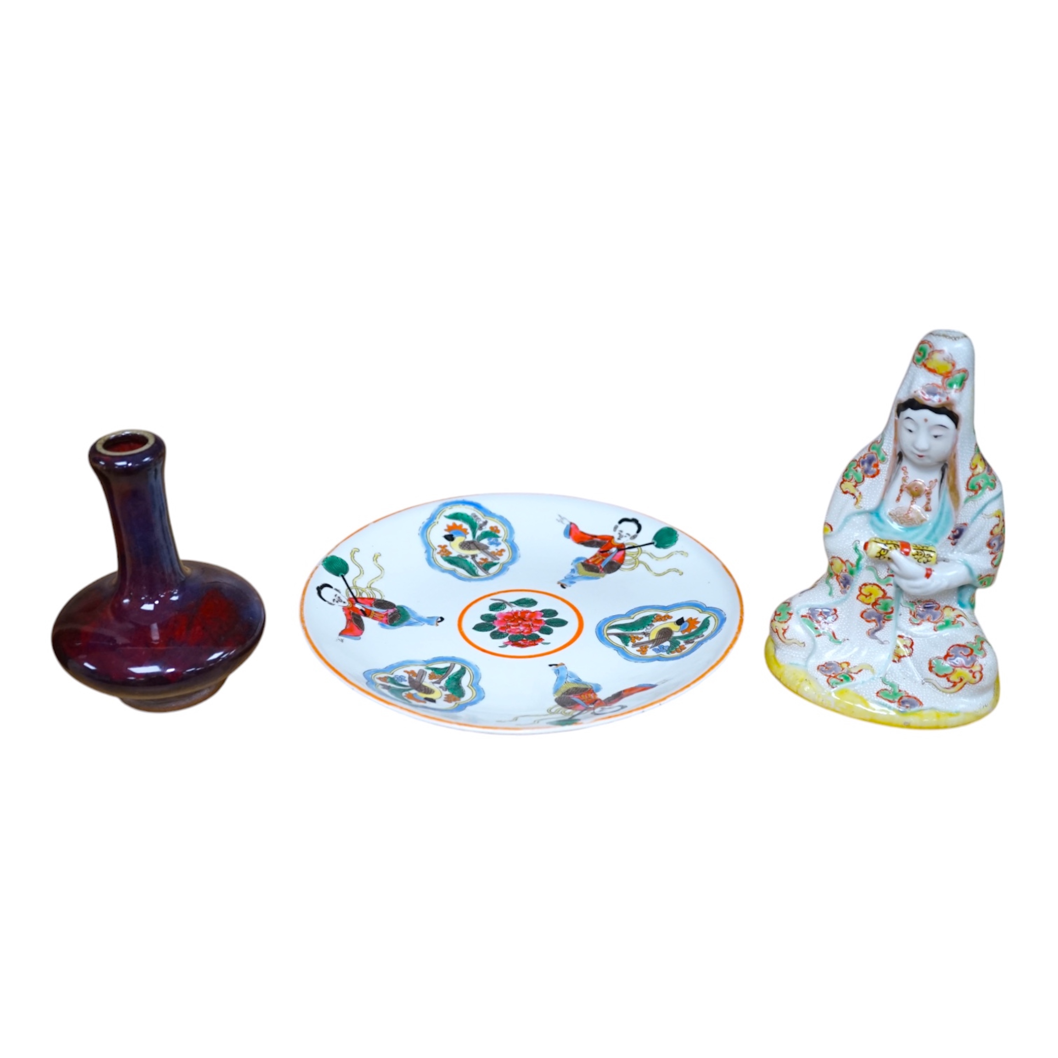 A Japanese porcelain seated figure of Kwannon, a flambé vase and a figural saucer dish, saucer dish 21.5 cm diameter. Condition - fair to good